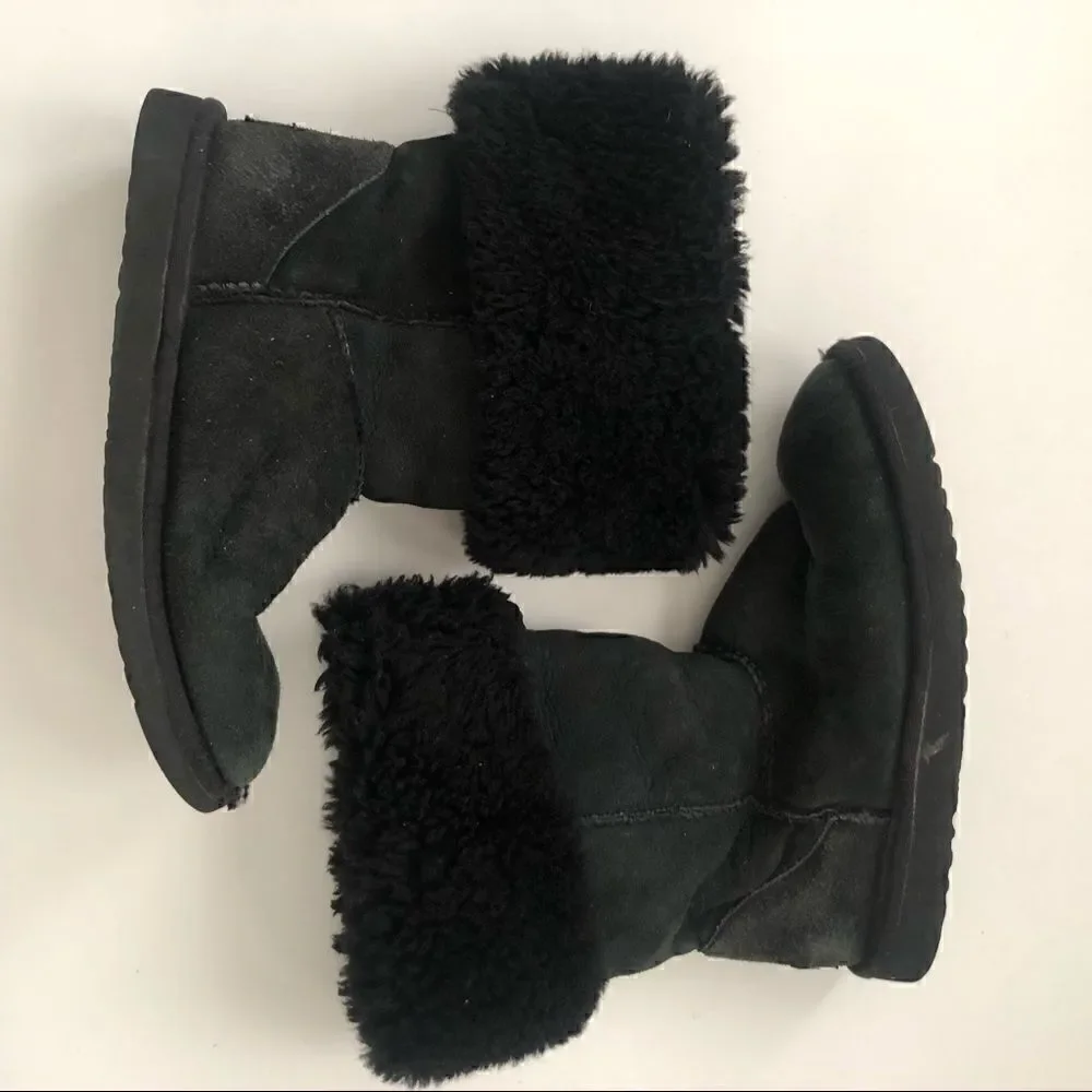 Ugg’s classic tall boots in black shearling lined